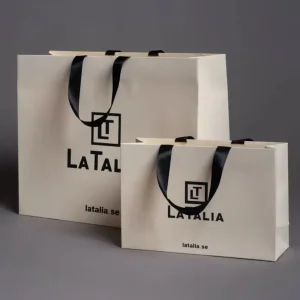 Bolsa de papel blanca personalizada con logo para regalo, con asas de cinta, para ropa de marca de lujo al por mayor para pequeñas empresas