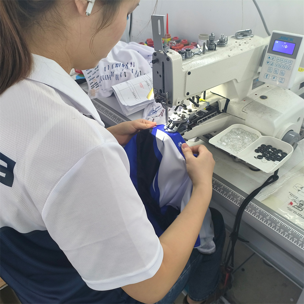 Button up machine at Achieve Sportswear factory