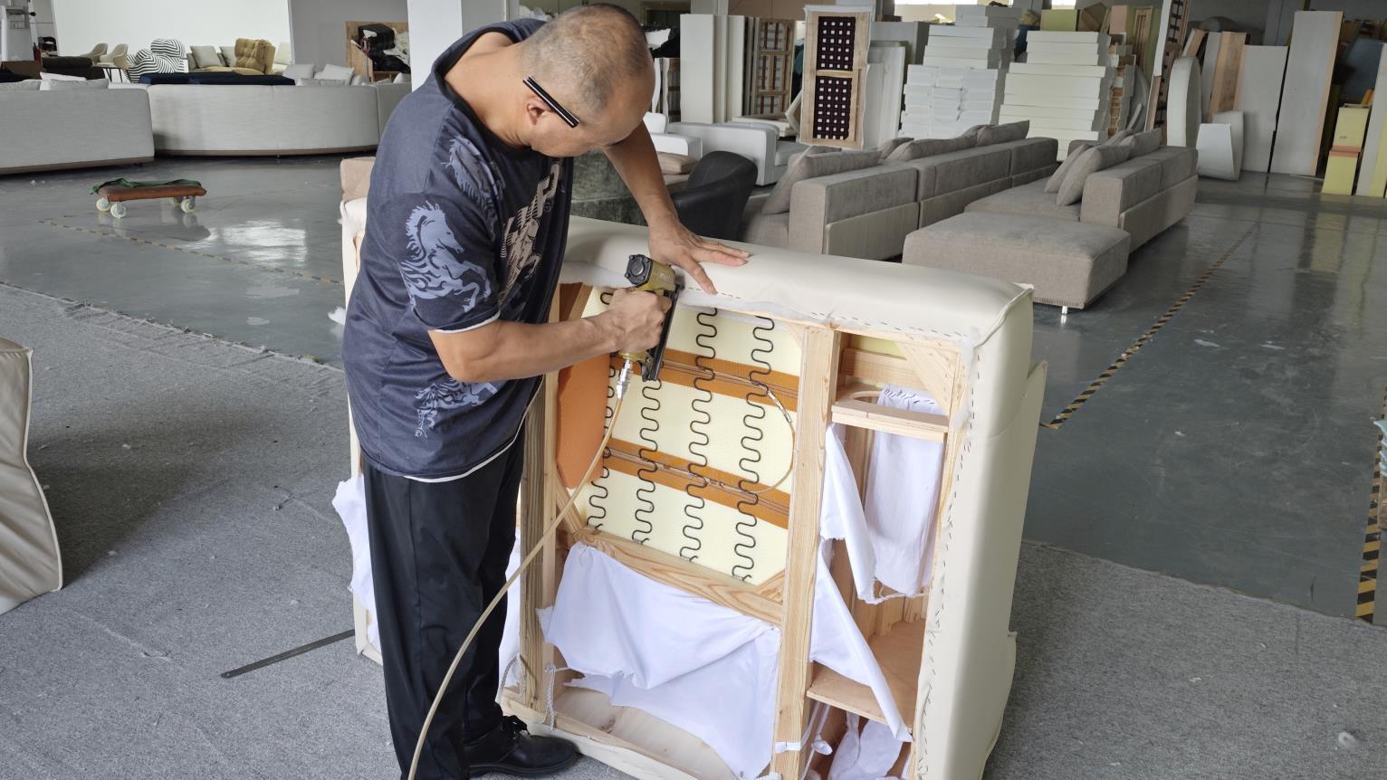 Final furniture assembly stage at Ambrose Home manufacturing plant