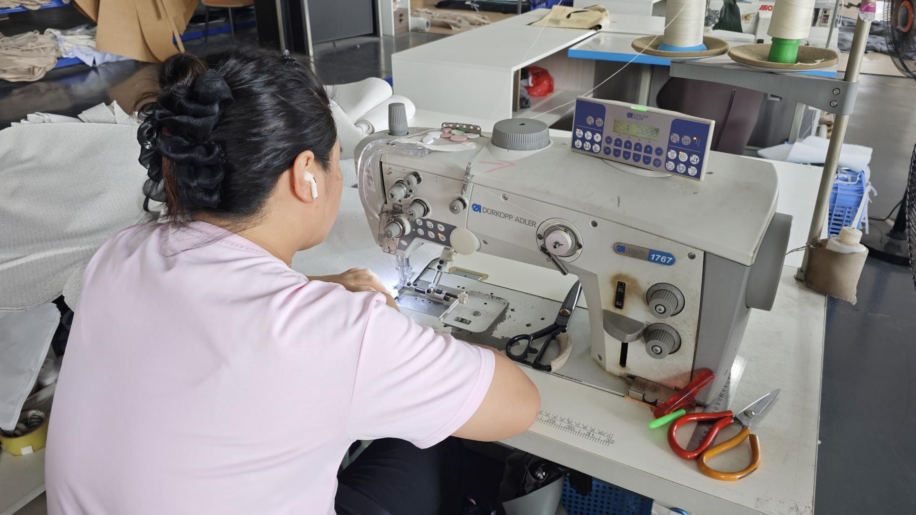 Skilled sewing technicians hand-finishing upholstery at Ambrose Home factory