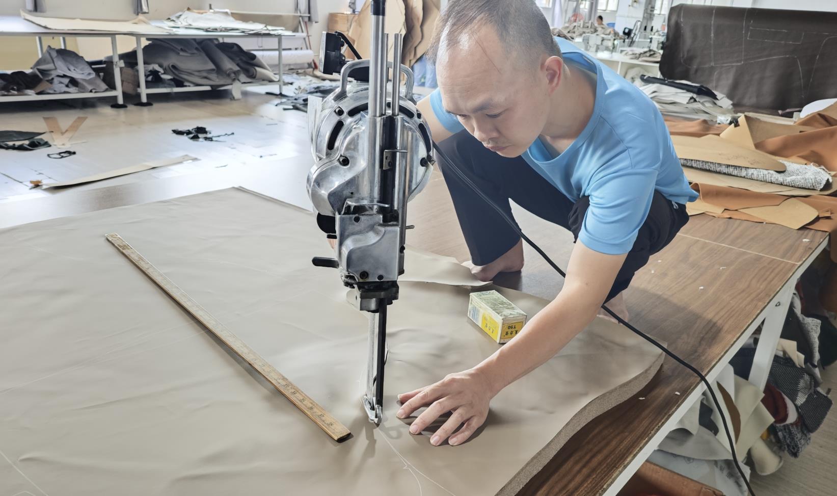 Precision leather cutting for upholstered furniture at Ambrose Home production line
