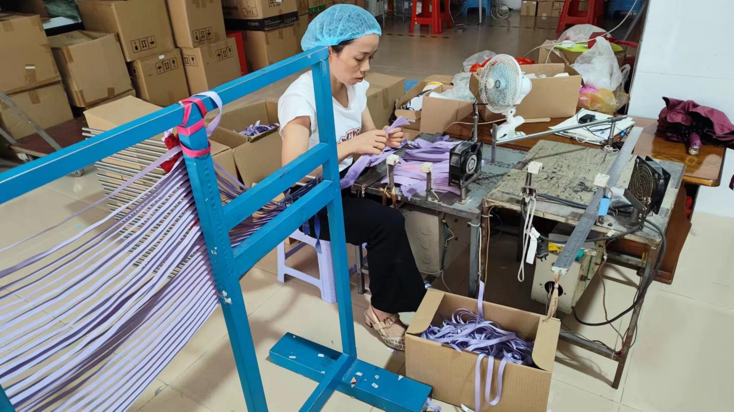 Cutting paper into flower petal shapes using Aoke computer cutting machine at Arden Decor