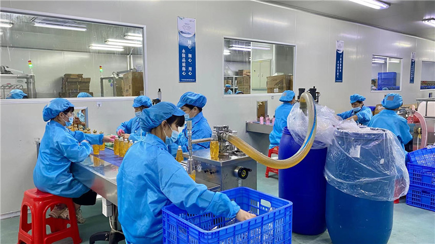 Precision filling process for lip gloss and lip balm products at Jenae Beauty factory
