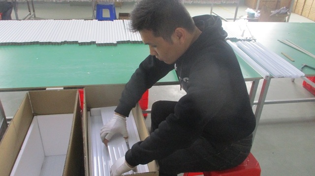 Quality inspector calibrating an optical sensor in the testing lab