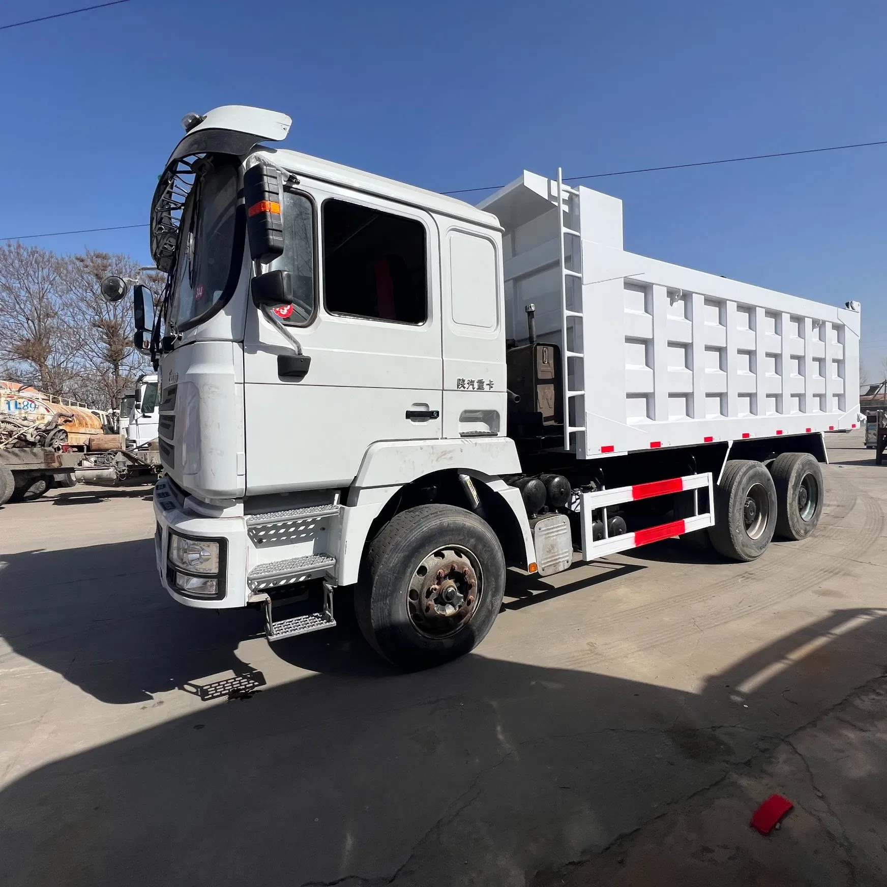 Heavy Construction Transport Vehicles. Chinese Shakman Dump Trucks with 10 Wheels and 12 Wheels, Box-Type Dump Trucks, Freight Vehicles