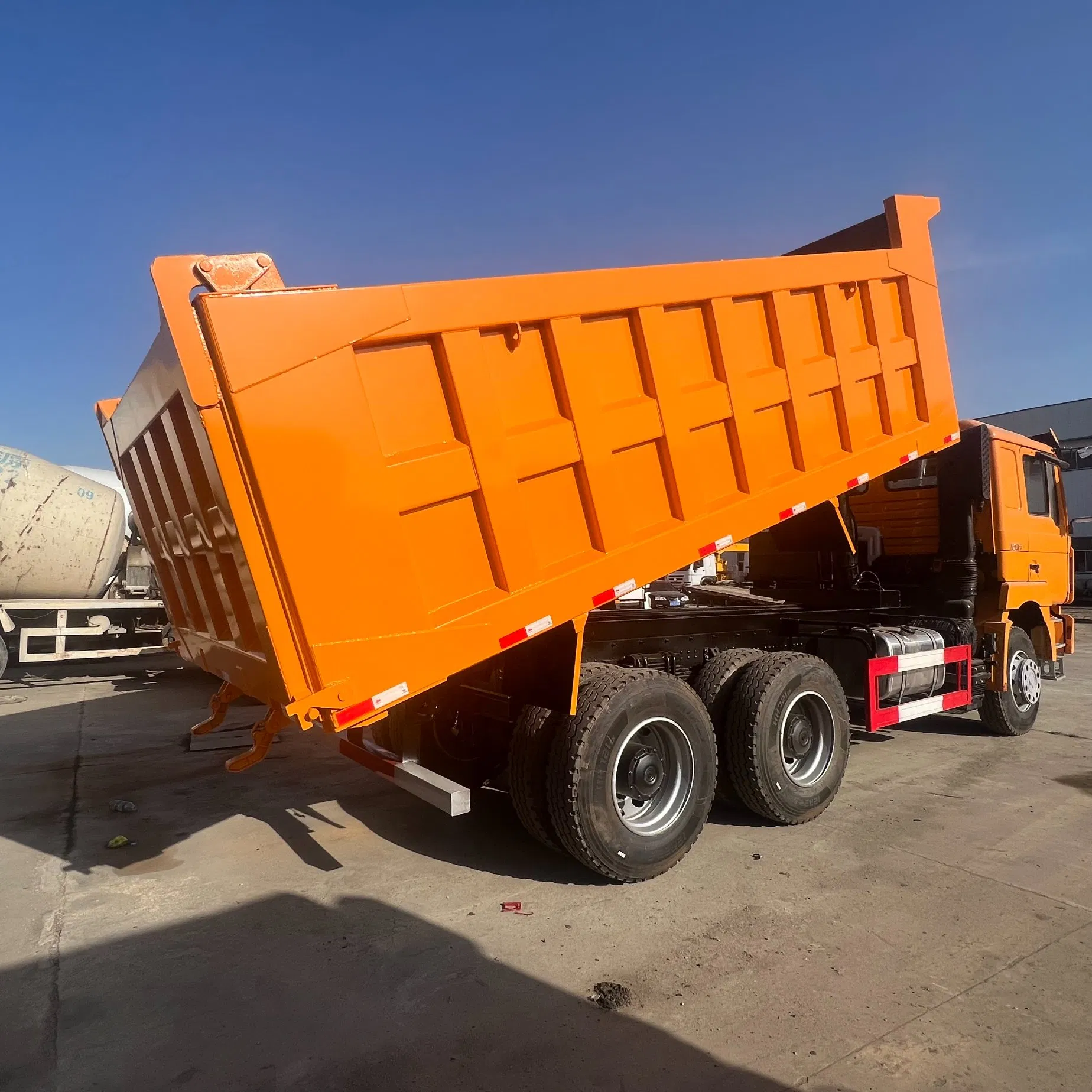 Heavy Construction Transport Vehicles. Chinese Shakman Dump Trucks with 10 Wheels and 12 Wheels, Box-Type Dump Trucks, Freight Vehicles