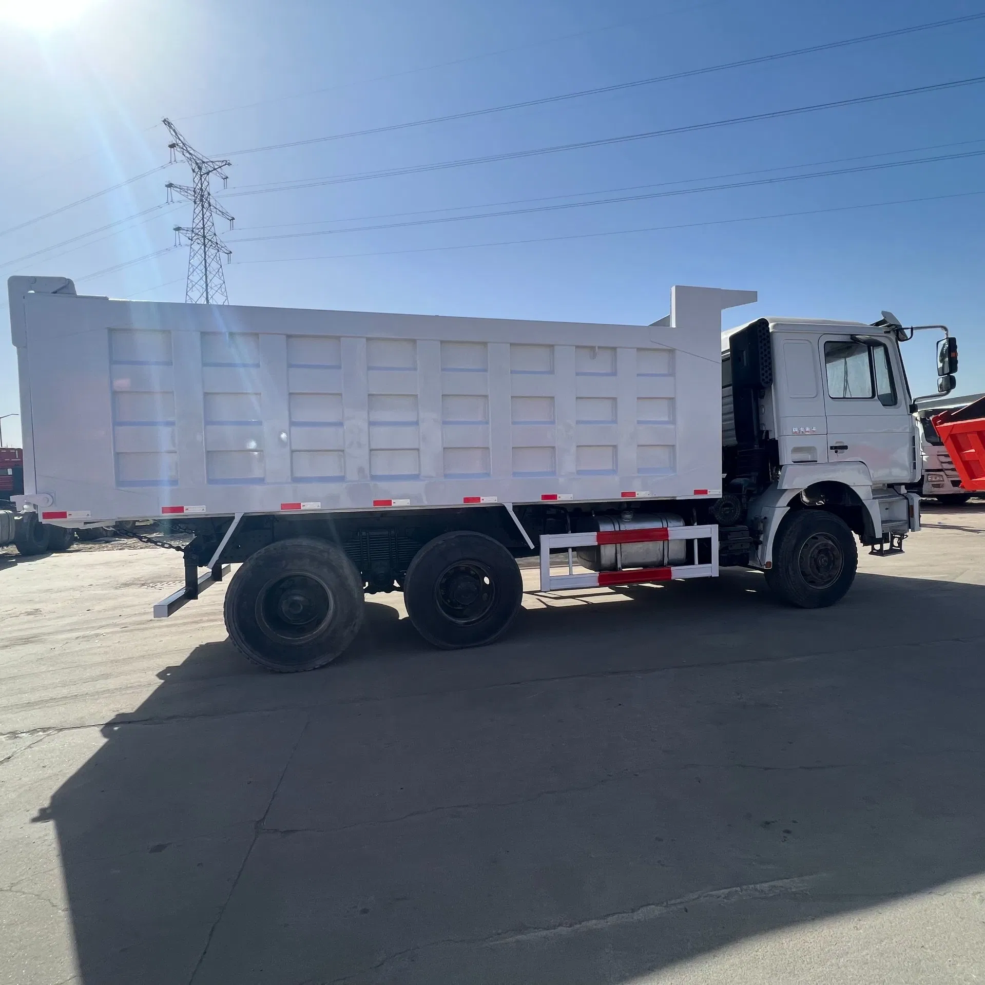 Heavy Construction Transport Vehicles. Chinese Shakman Dump Trucks with 10 Wheels and 12 Wheels, Box-Type Dump Trucks, Freight Vehicles