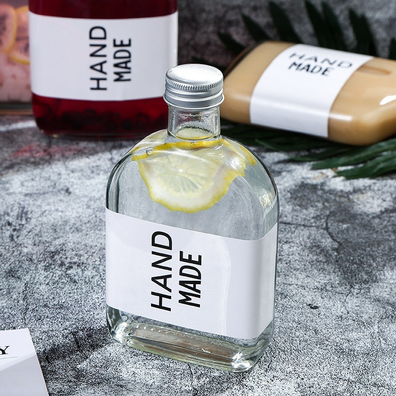 Hot Sale Reusable Glass Water Bottles with Stainless Steel Lids to Store Home Brews, Oils, Vinaigrettes, Wines, Beer, Teas