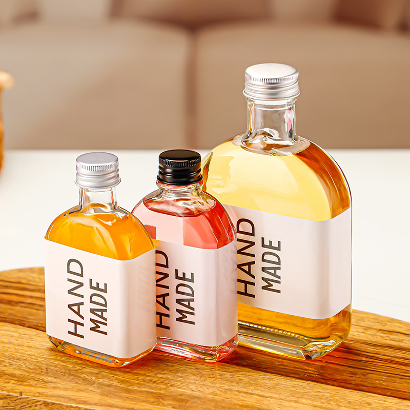 Hot Sale Reusable Glass Water Bottles with Stainless Steel Lids to Store Home Brews, Oils, Vinaigrettes, Wines, Beer, Teas