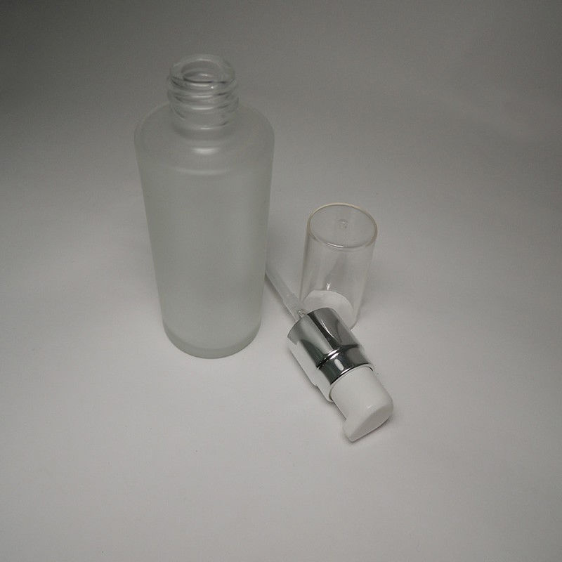 Best Seller 50ml Empty Cylinder Shape Glass Bottle with 18/415 Neck Size White Actuator Lotion Pump and Oversize Cap for Facial Lotion
