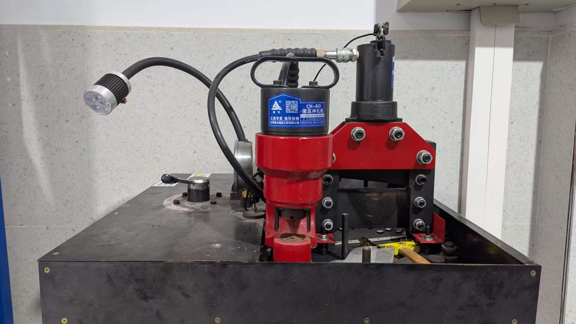 Hydraulic punching machine operation at Bowser Electric factory