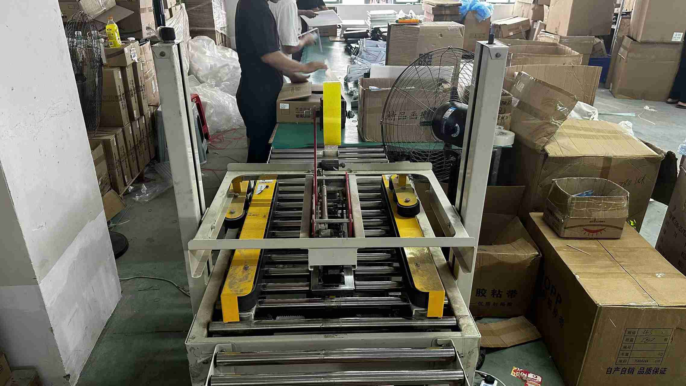 Industrial wrapping machine operation at Cappy Light export packaging facility