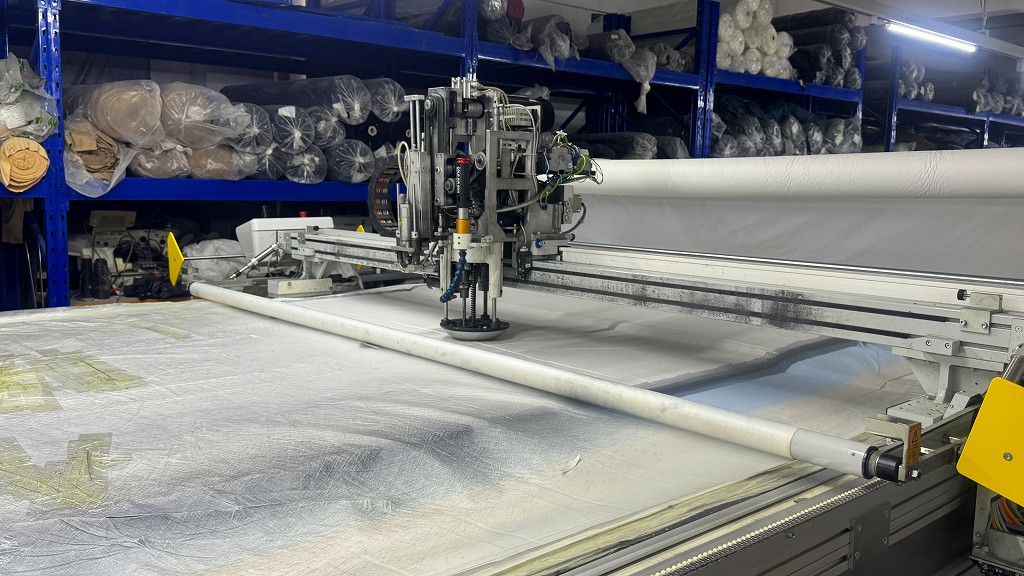 Fabric cutting process at CGE Clothing manufacturing facility