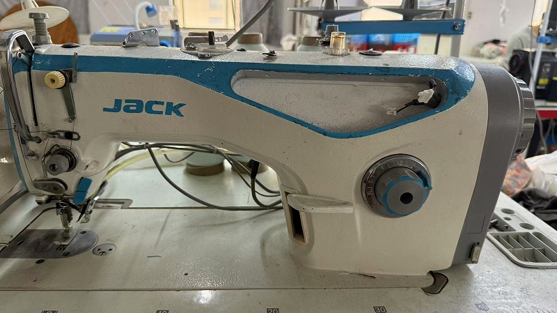 Professional sewing machine for activewear manufacturing at CGE Clothing