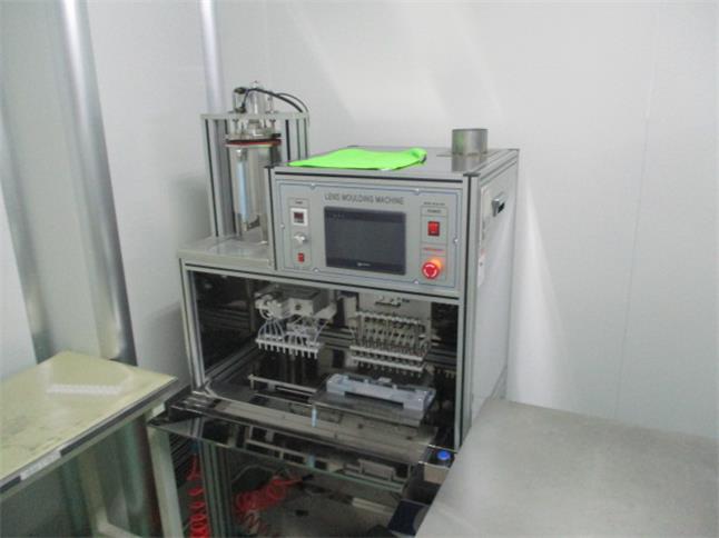 Mold filling process — automated dispensing of lens polymer into precision cast molds