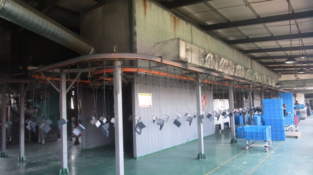 Dixon automated painting machine for consistent electrostatic powder coating on outdoor light fixtures