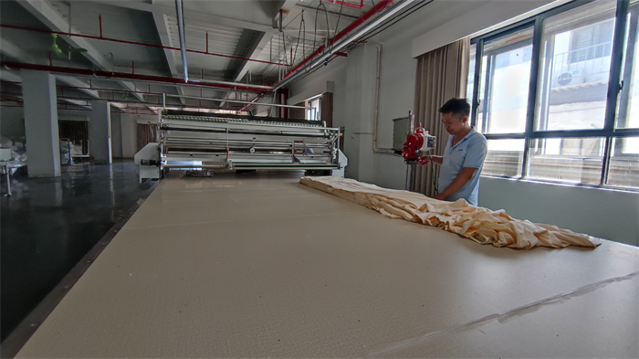 Precision fabric cutting process at Eglin Fashion garment manufacturer