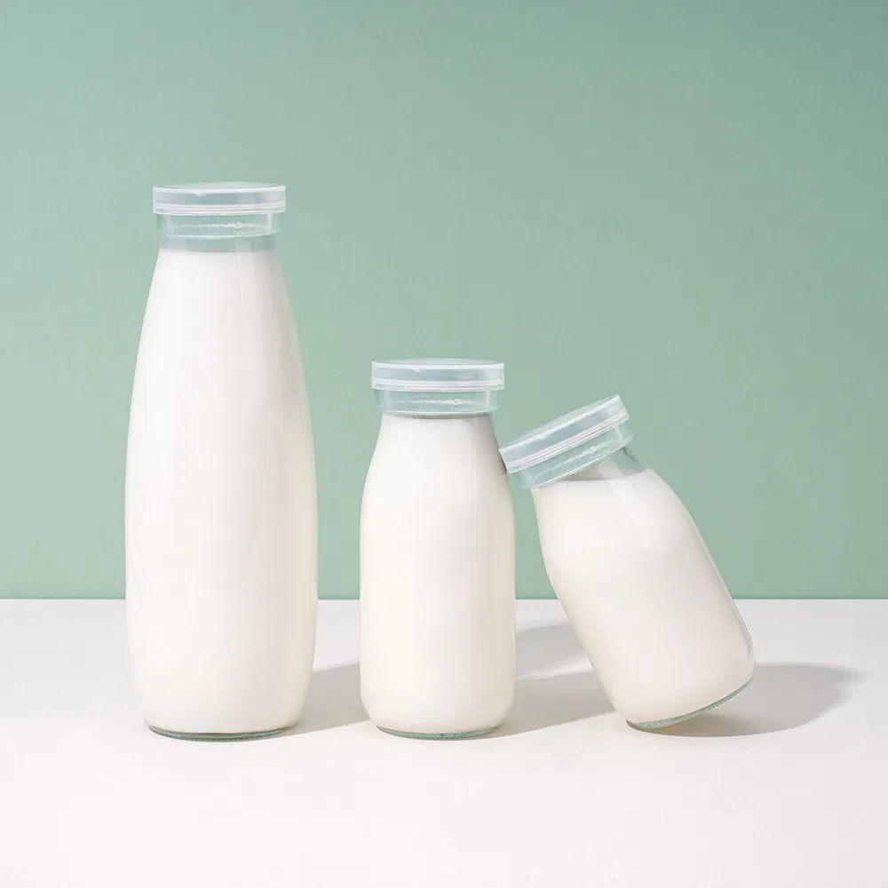 Factory Direct OEM Custom Logo Drinking Bottle Empty Transparent Glass Beverage Milk Bottles with Plastic Lids