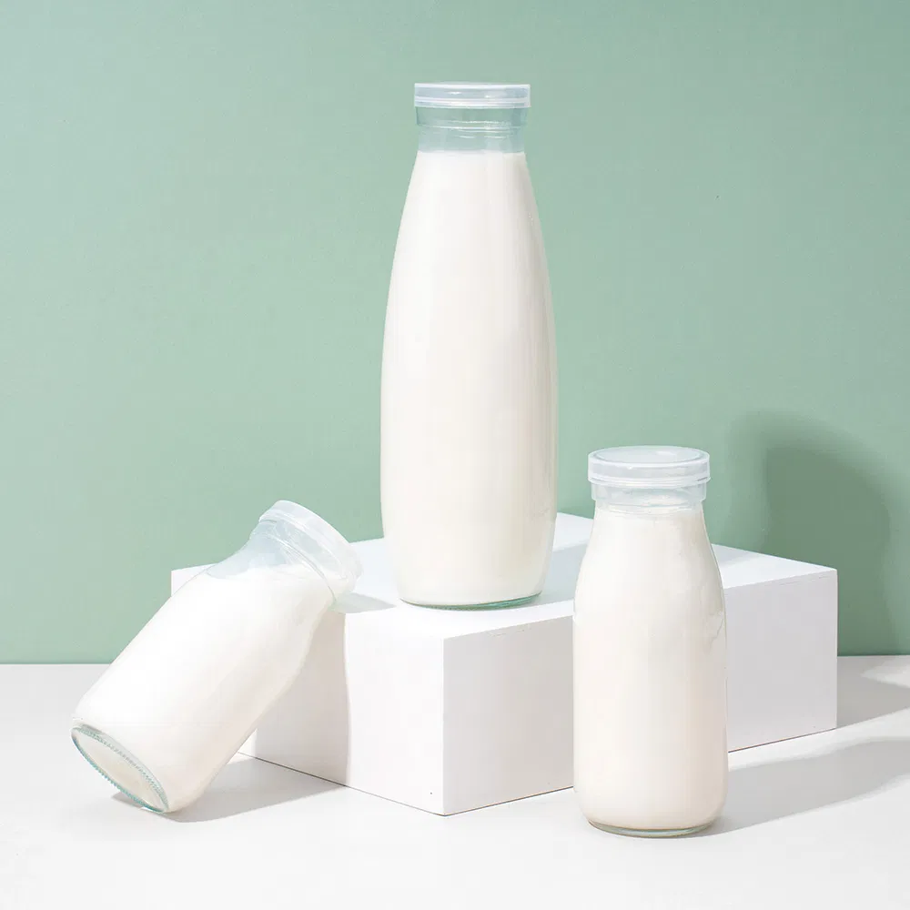 Factory Direct OEM Custom Logo Drinking Bottle Empty Transparent Glass Beverage Milk Bottles with Plastic Lids