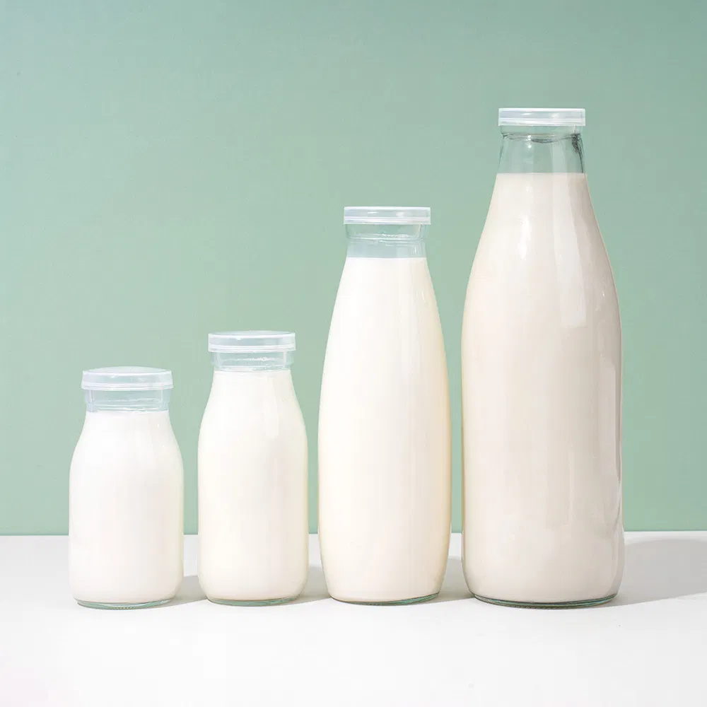 Factory Direct OEM Custom Logo Drinking Bottle Empty Transparent Glass Beverage Milk Bottles with Plastic Lids