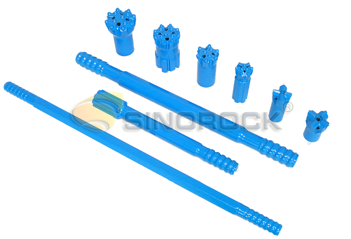 Top hammer rock drilling tools
