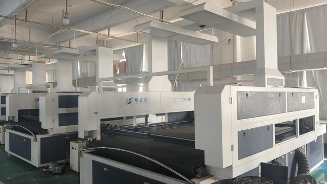 Production team member auditing textile details to verify quality consistency.