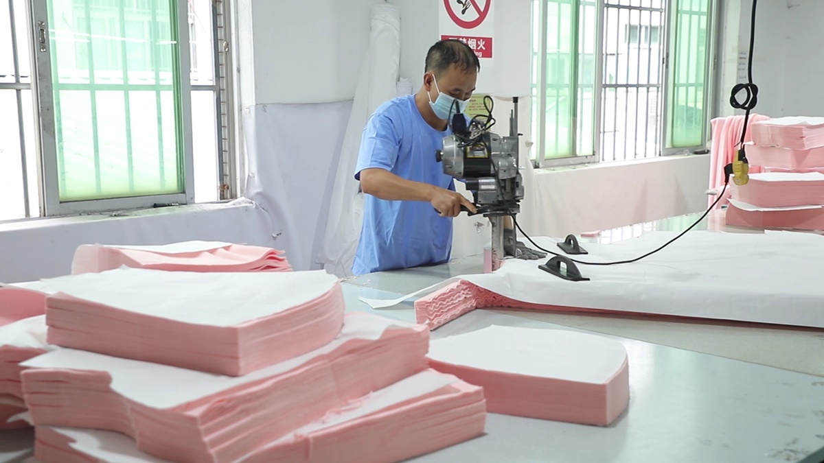 Fabric cutting process at NovaFair garment manufacturing facility