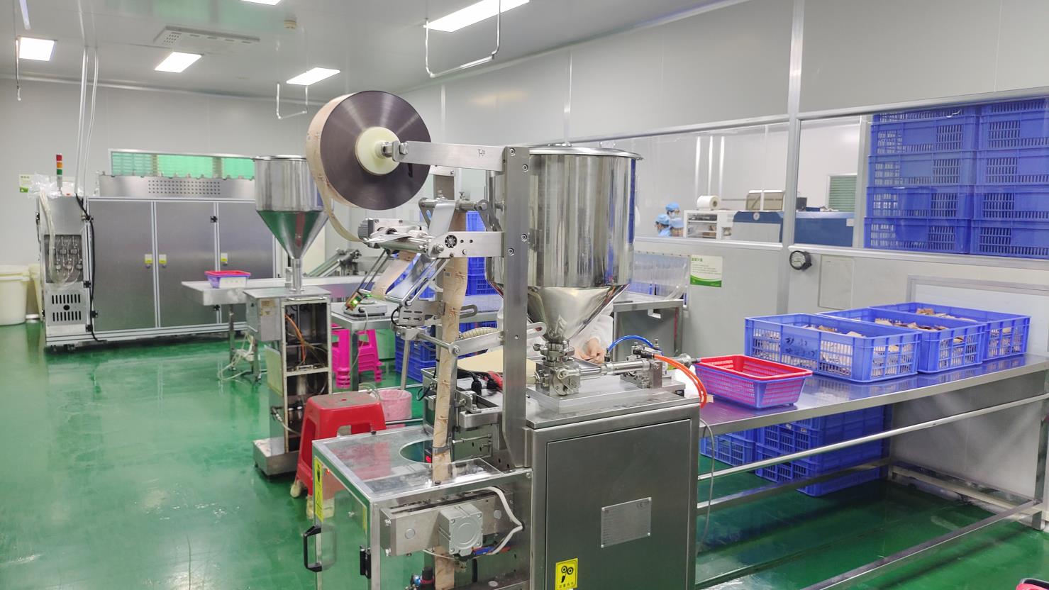Precision filling line at Fmo Beauty cosmetics factory — filling lip gloss and foundation bottles