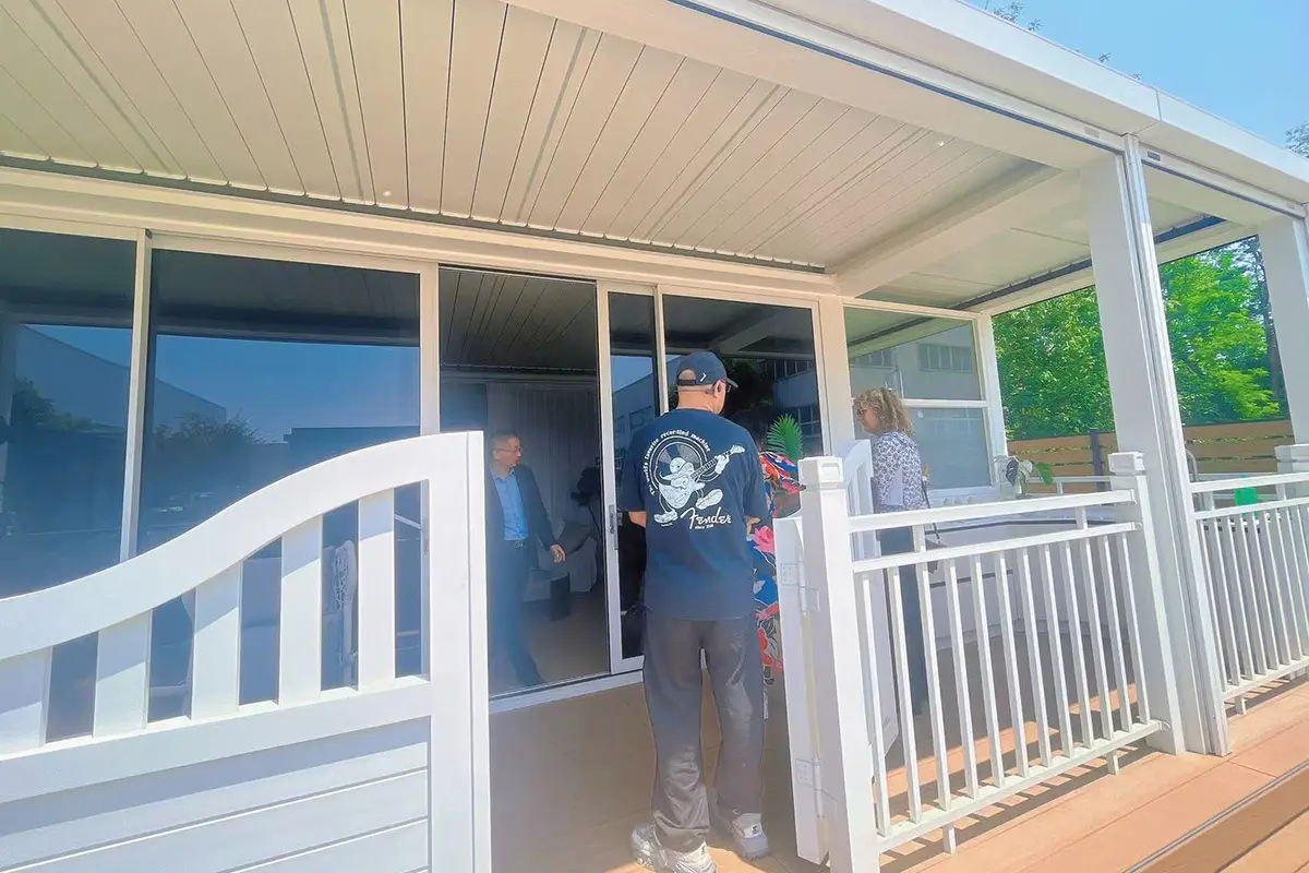 North American client evaluating aluminum louvered pergola quality at trade fair