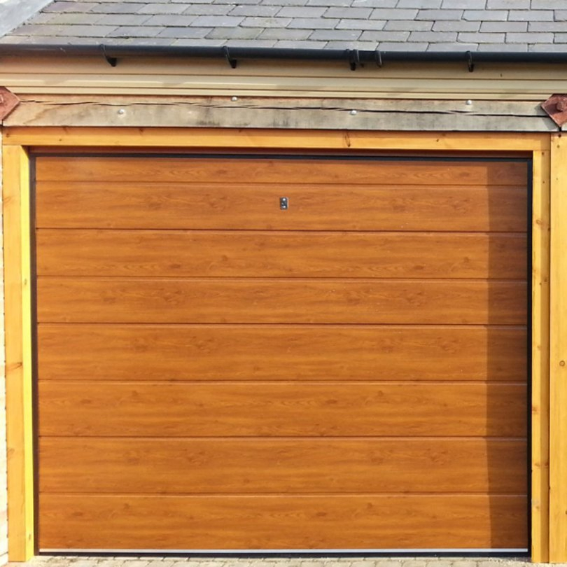 Pressure-Treated Sectional Garage Door for Resisting Rot in Humid Environments