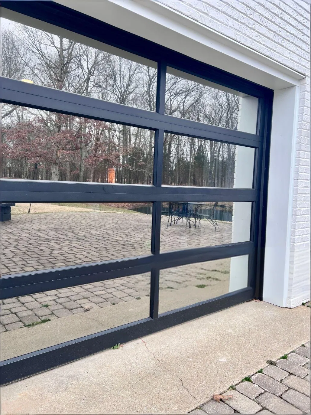 Modern Glass Garage Door with Black Aluminum Frame for Contemporary Residential and Commercial Building Applications