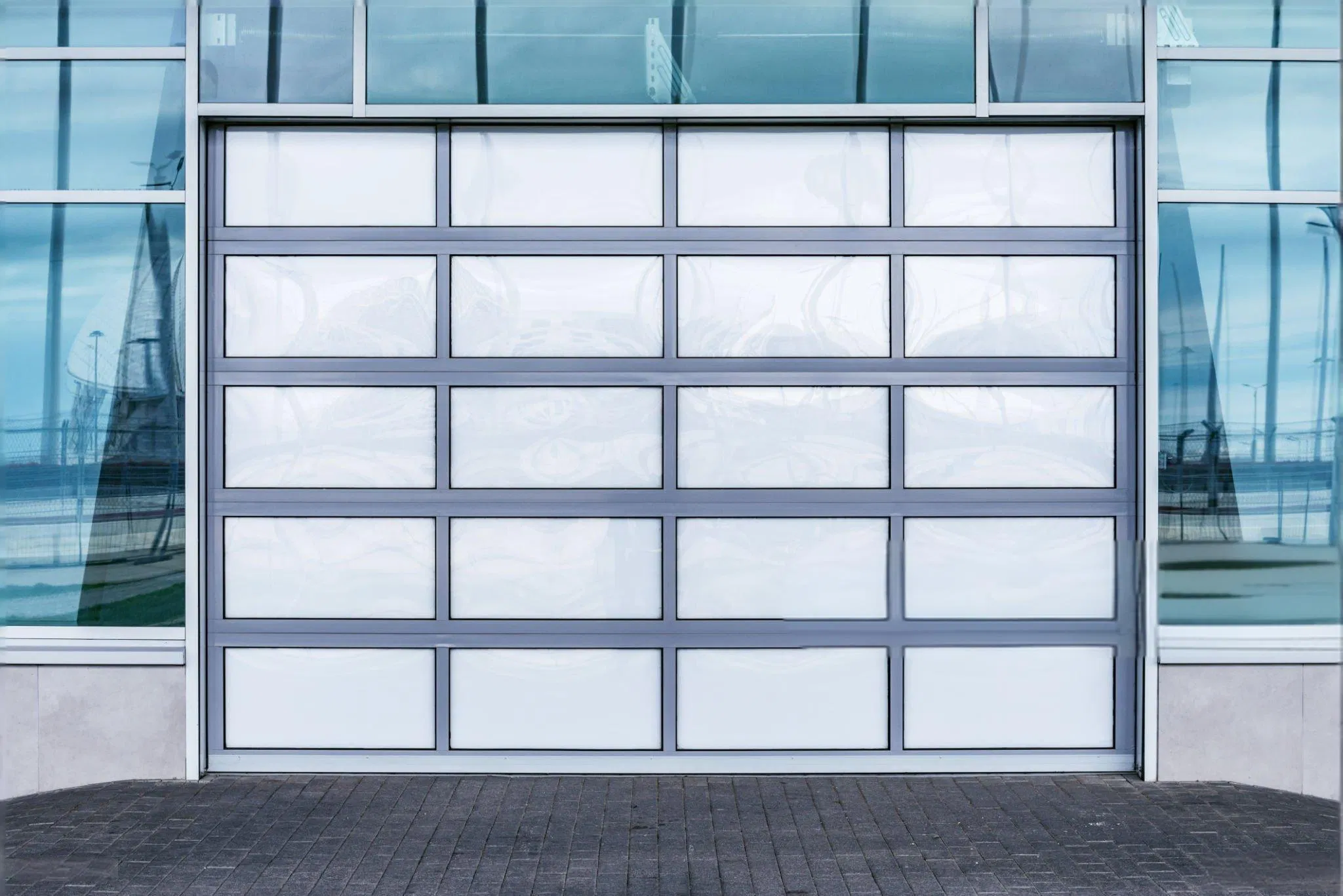 Modern Glass Garage Door with Black Aluminum Frame for Contemporary Residential and Commercial Building Applications