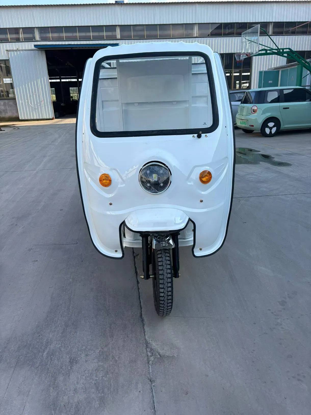 Reinforced Electric Trike with Enclosed Cabin for Secure Package Delivery Solutions