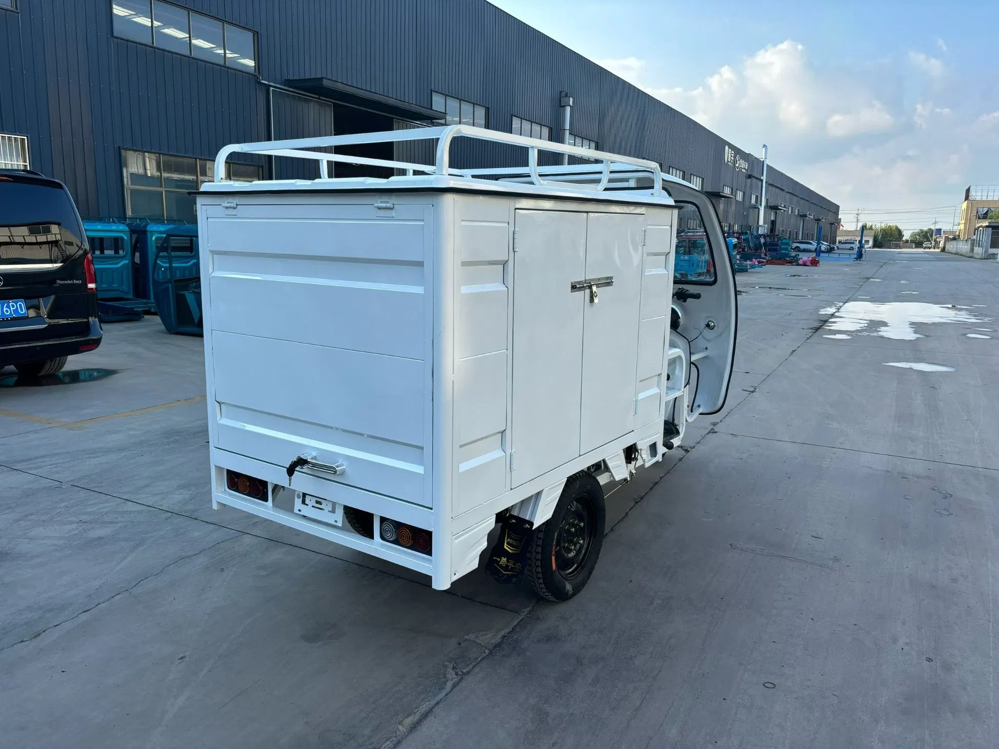 Reinforced Electric Trike with Enclosed Cabin for Secure Package Delivery Solutions