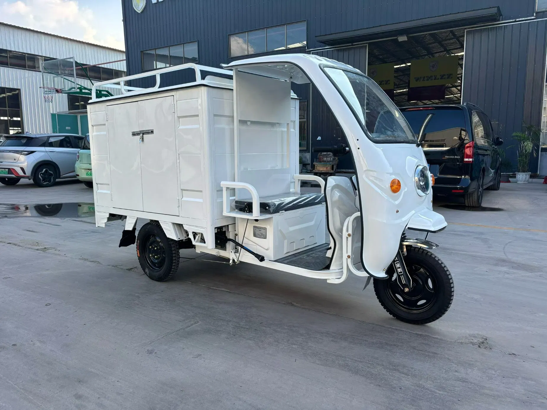 Reinforced Electric Trike with Enclosed Cabin for Secure Package Delivery Solutions
