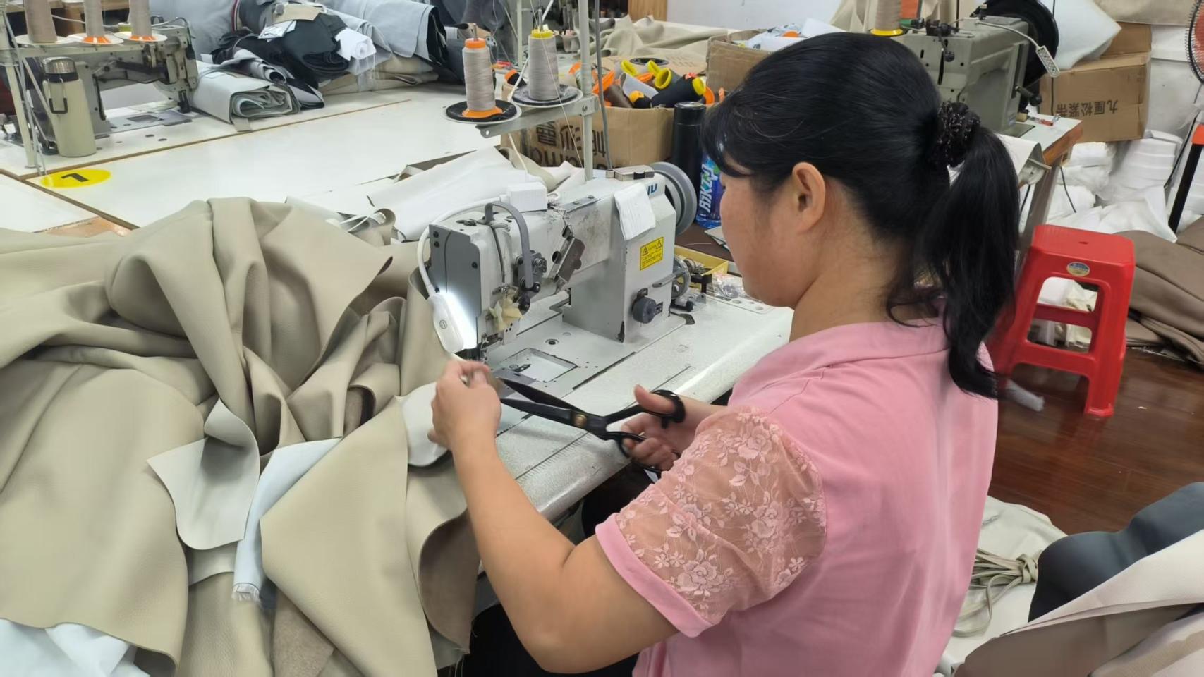 Sewing upholstery fabric for furniture production at Hark Homes