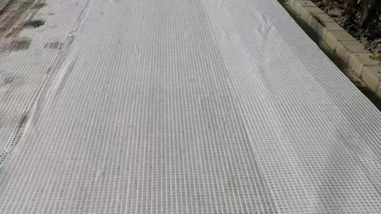 Warp knitted composite geotextile structural layer
