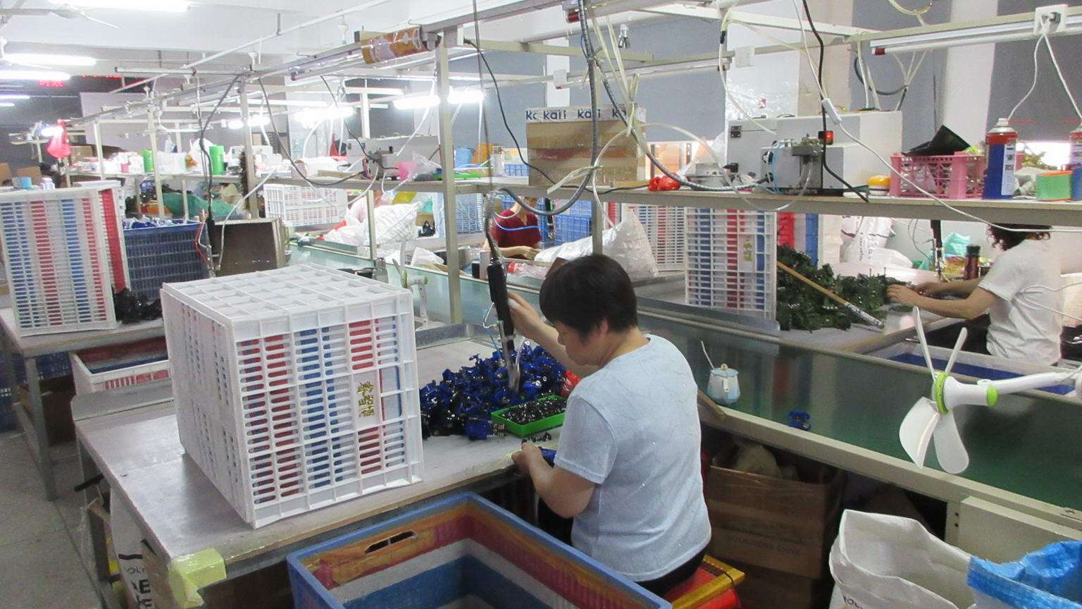 Assembly line workers assembling children's electric ride-on toys at Hoopla Toys