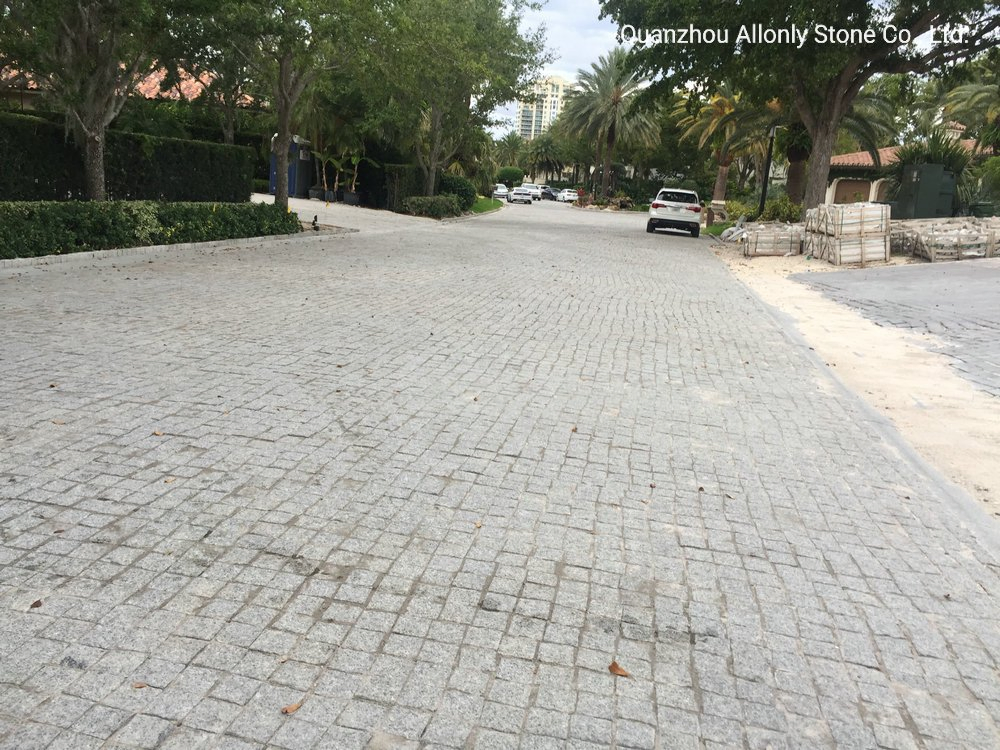 China Wholesale Cheap Natural Split Tumbledg603 Light Grey Granite Cobblestone Driveway Pavers Price