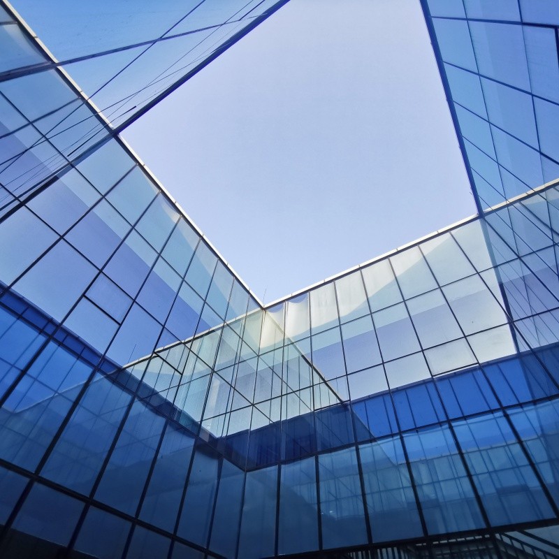 Silicone sealant applied to curtain wall glazing system on commercial building