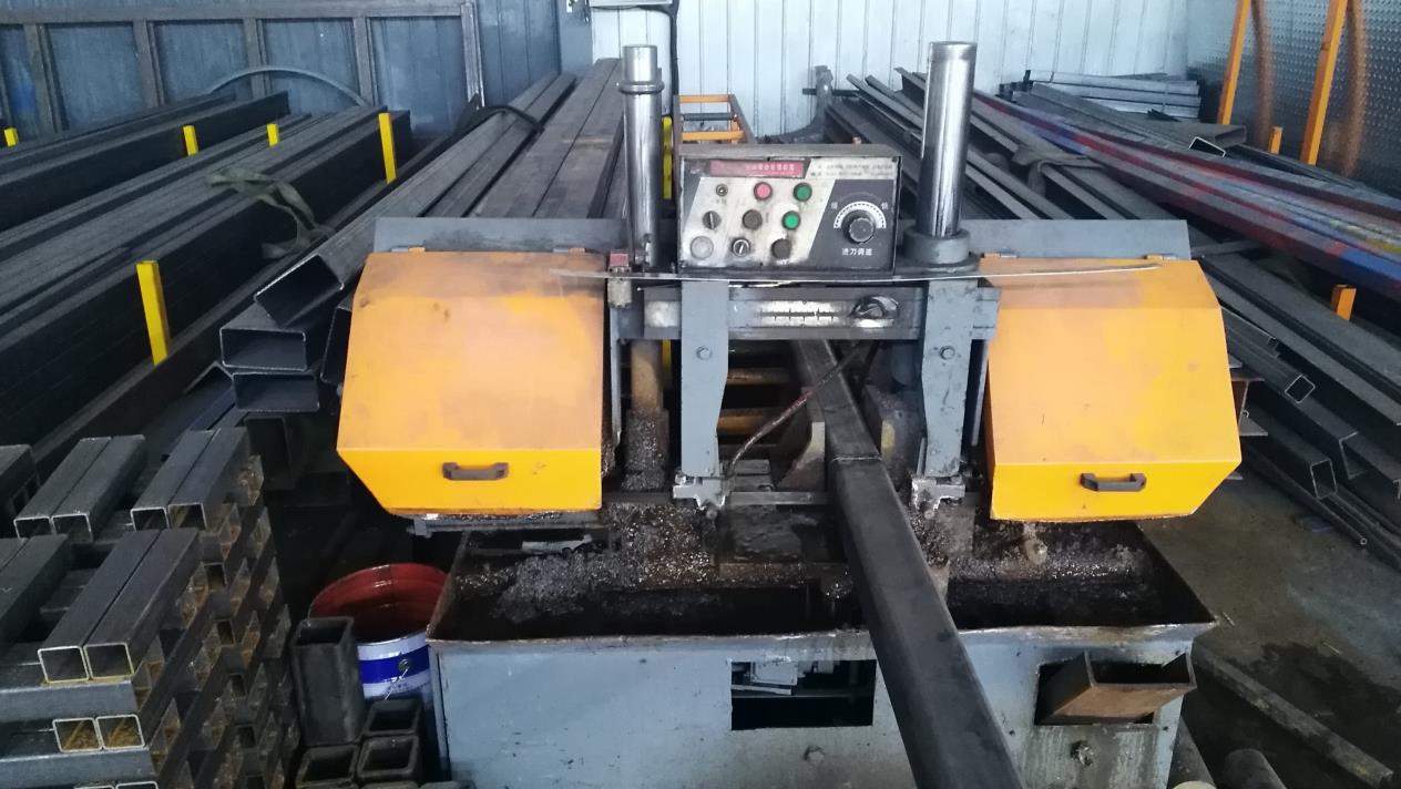 Sawing machine cutting steel materials for lift manufacturing