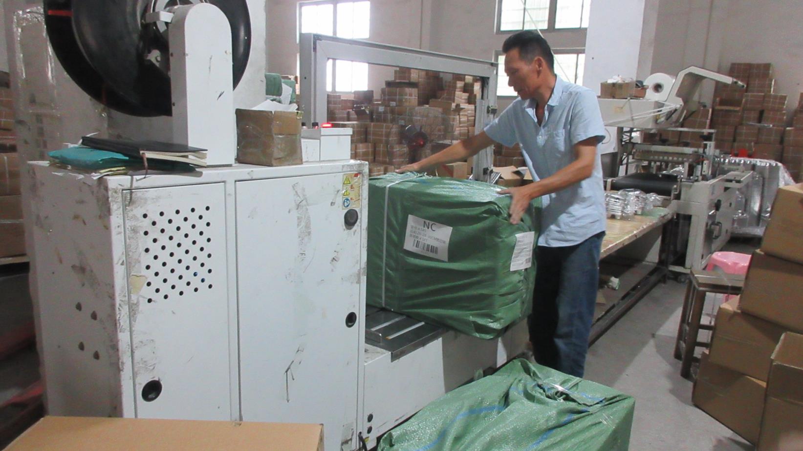 Secure packaging of stainless steel kitchenware for export shipping at Kaus Kitchen