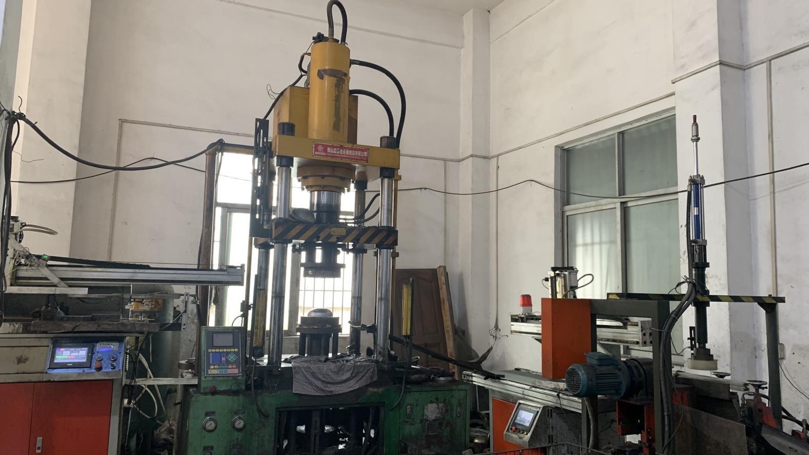 Industrial pulling machine used in kitchenware production at Fergus Kitchen