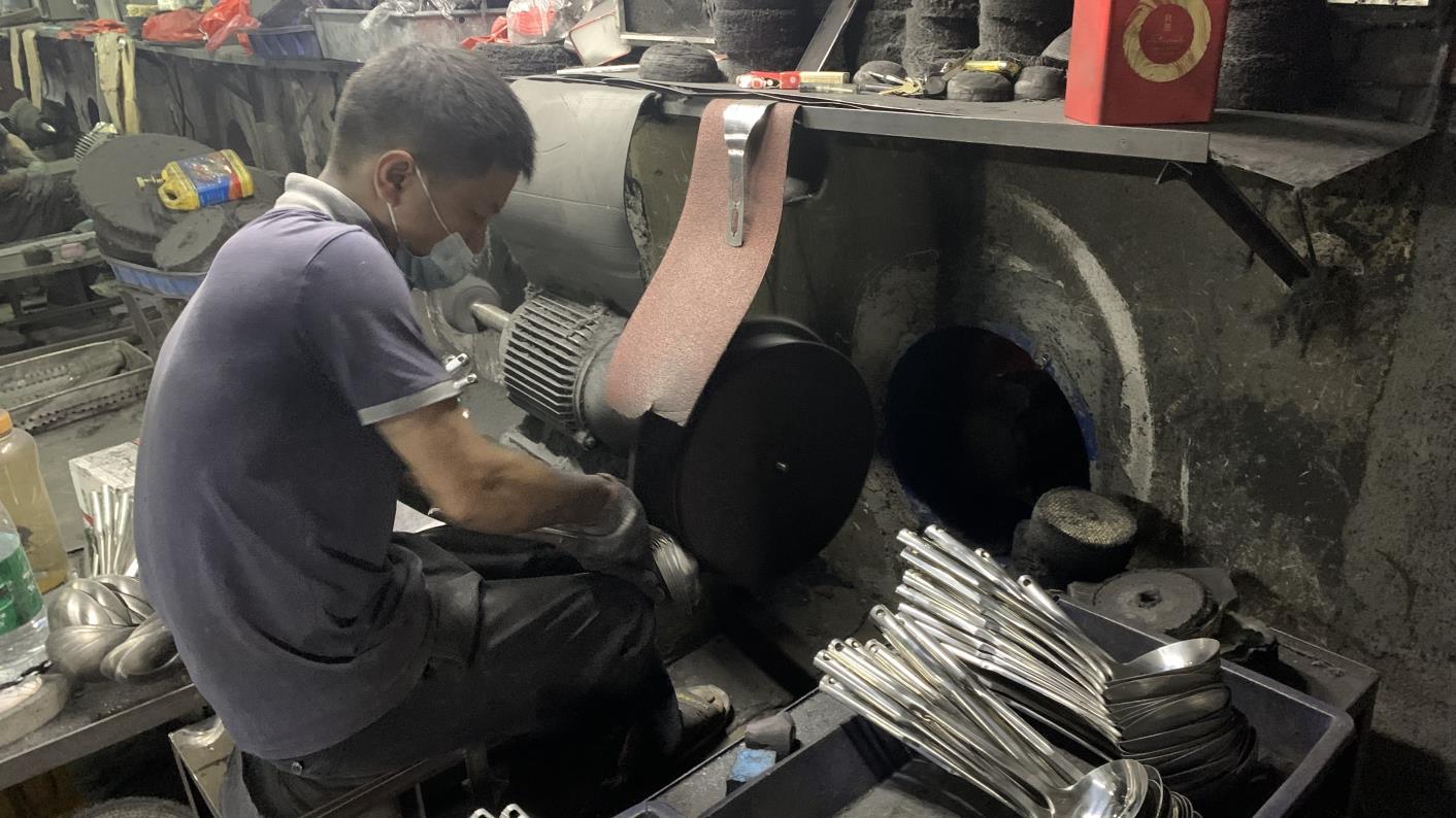 Precision trimming step during kitchenware manufacturing at Fergus Kitchen