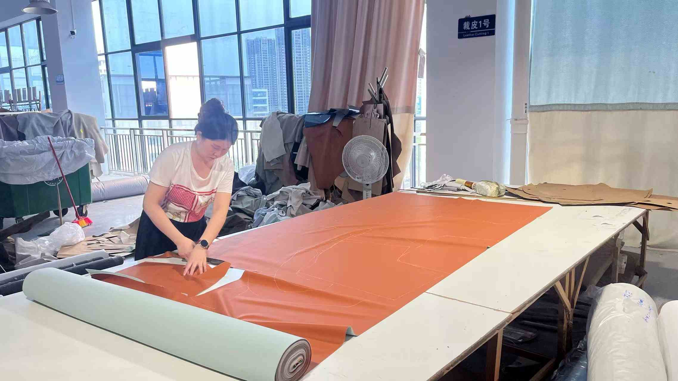 Manual fabric cutting and pattern preparation for custom furniture upholstery