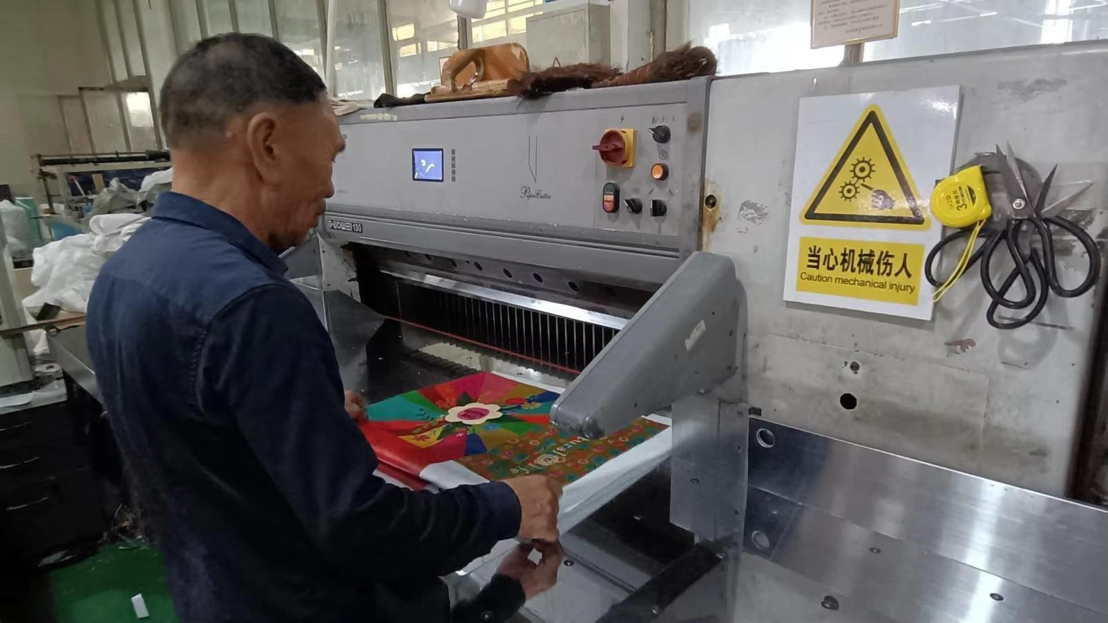 Fabric cutting process at LAHD Bag manufacturing facility — precision material cutting for gift bags
