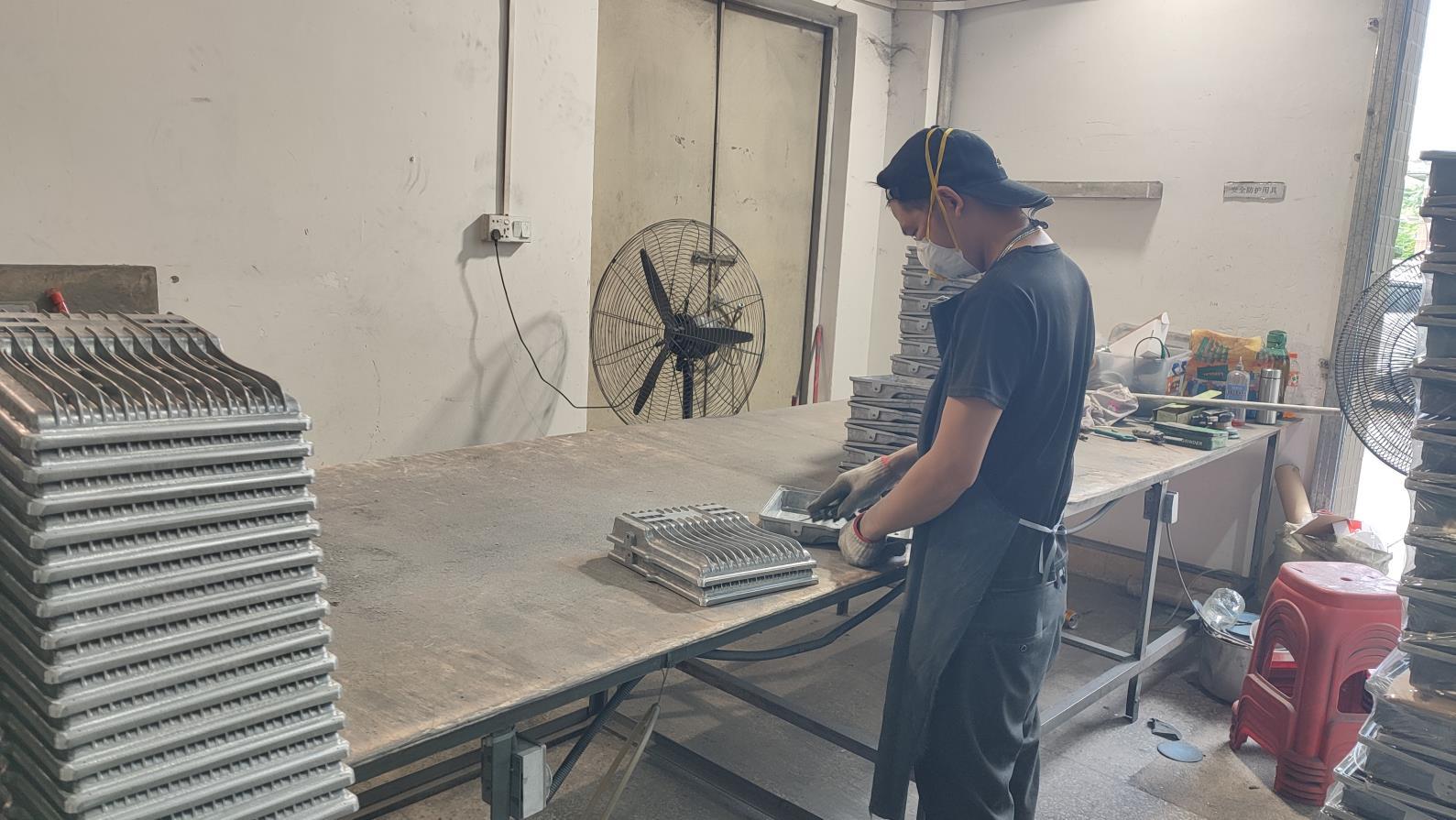 Trimming and deburring LED light parts at Lijah Light manufacturing