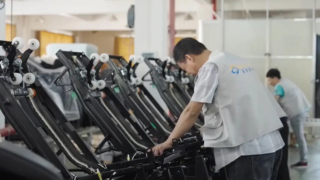 Massage chair assembly workshop with skilled technicians at work