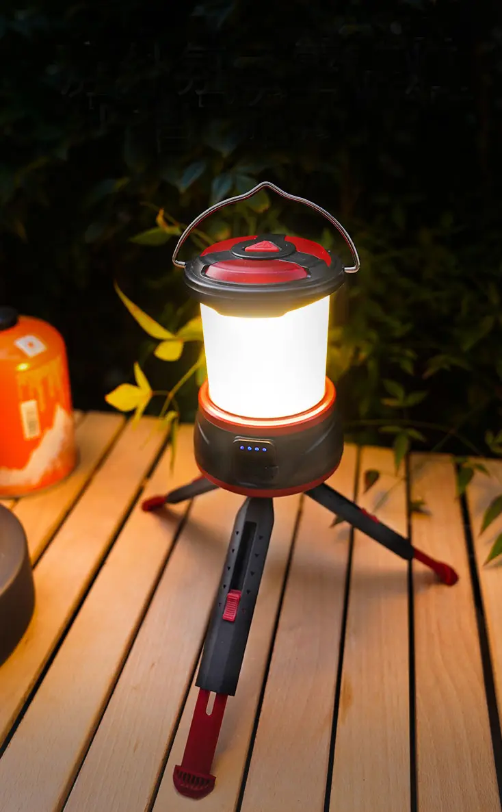 Camping lantern illuminating an outdoor campsite at night