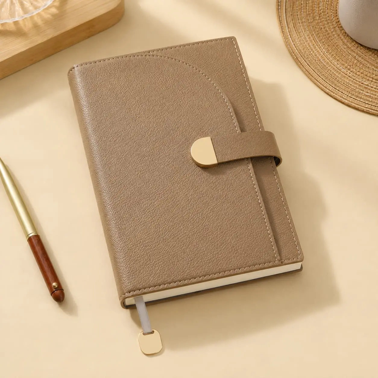 China Custom A5 Pebble PU Strap Closure Hardcover Notebook | 100gsm Lined Journal Manufacturer, Supplier